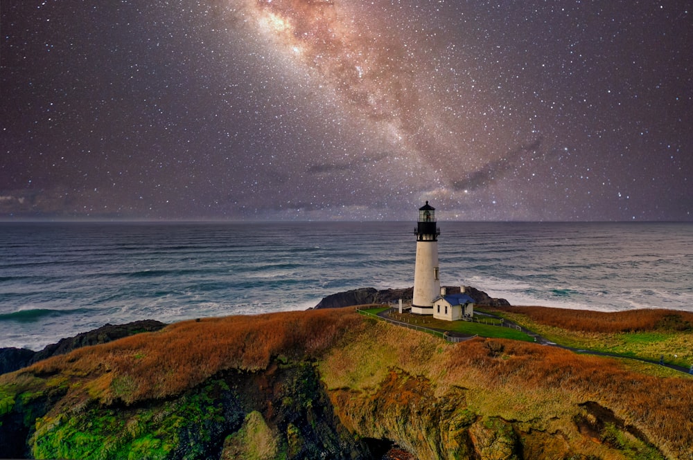 lighthouse under starry night