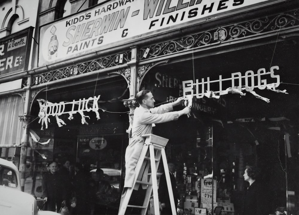 man decorating bull dogs signage