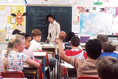 woman standing in front of children school teams background