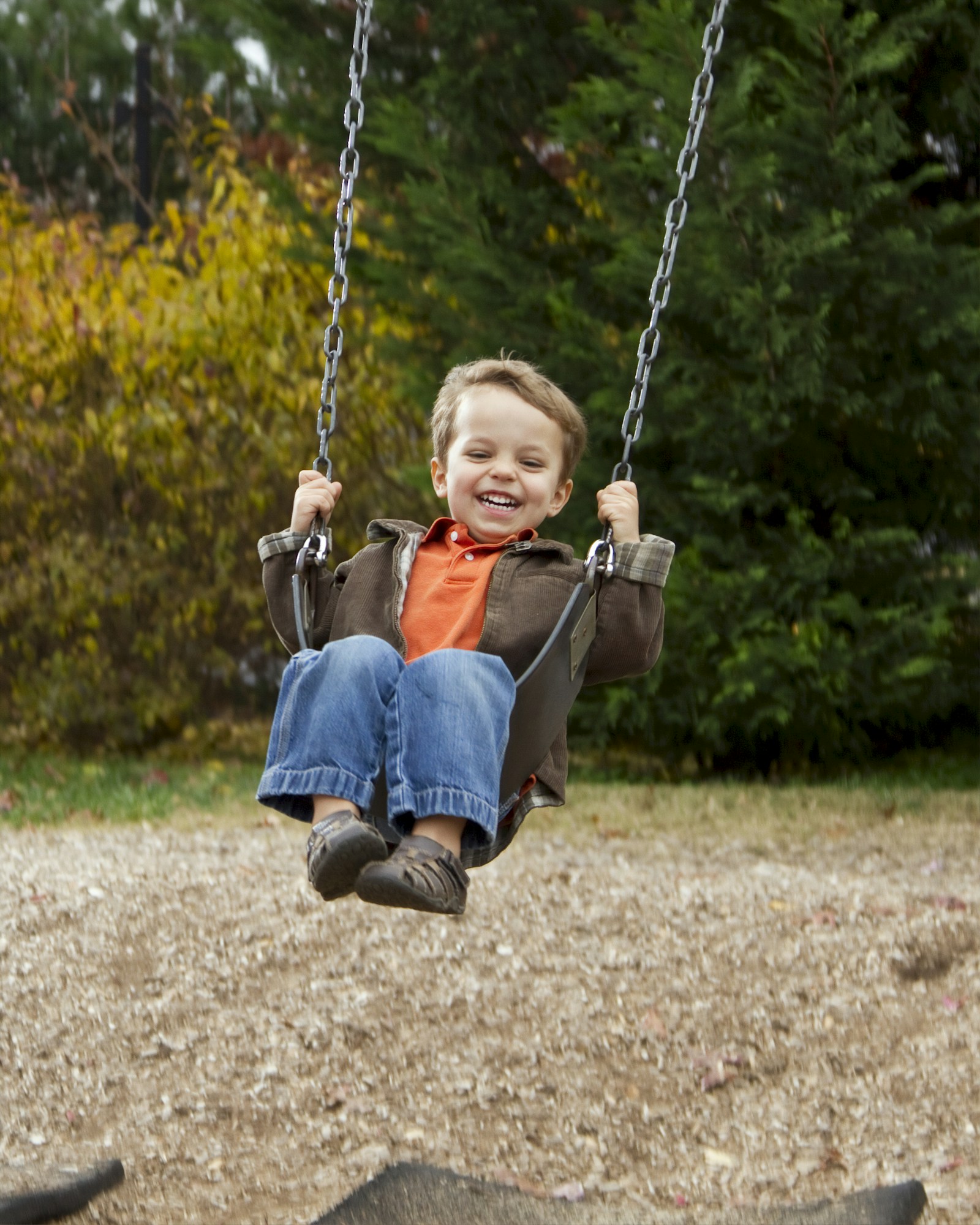 A child on a swingset in a suburban yard of North Kildonan