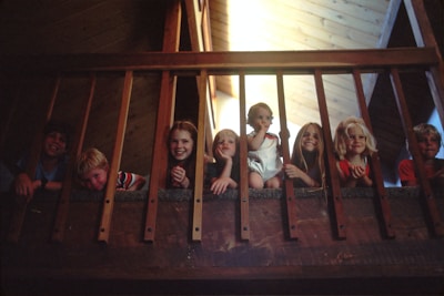 Children smiling brightly during an educational workshop under natural light.