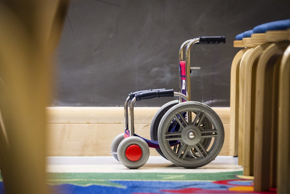 gray wheelchair beside chair