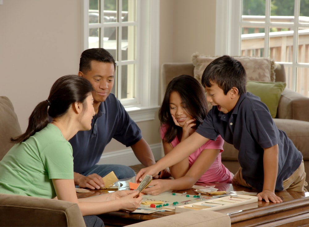 group of family and friends on summer vacation beside coffee table