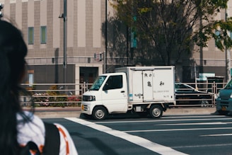 white box truck running on the road