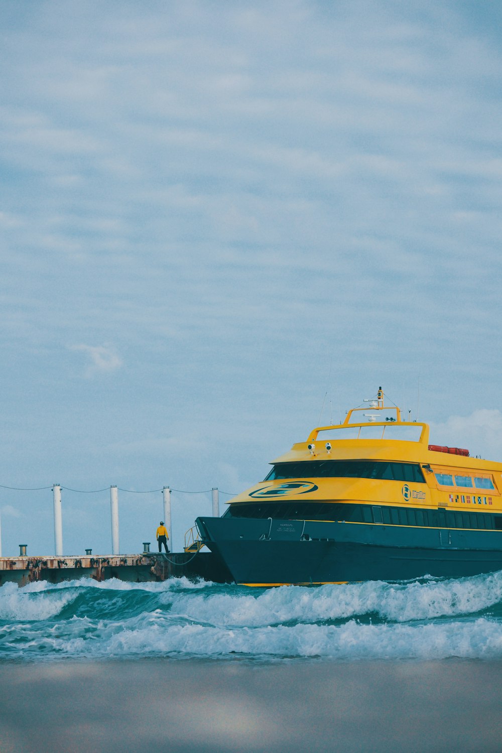 yellow and black ship beside dock