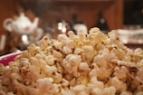 A close-up of popcorn and drinks on a coffee table.