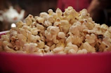 A colorful bowl of buttery popcorn, perfect for sharing at the game.