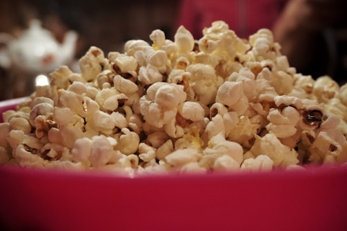 A bowl overflowing with hipopopamus popcorn, highlighting the vivid colors and textures of the flavors.