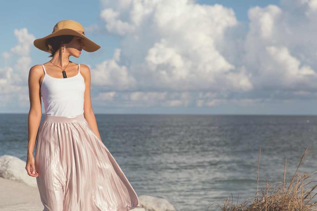 woman walking near body of water,