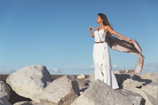 woman standing on rocks during day