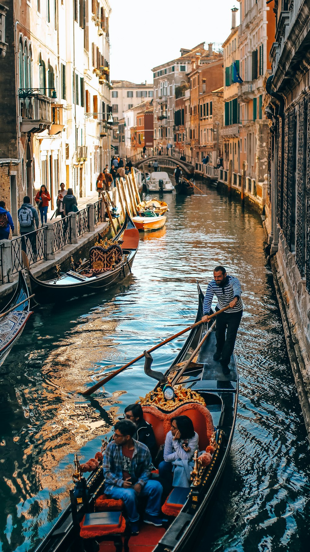 people in boat on Venice Canal during daytime