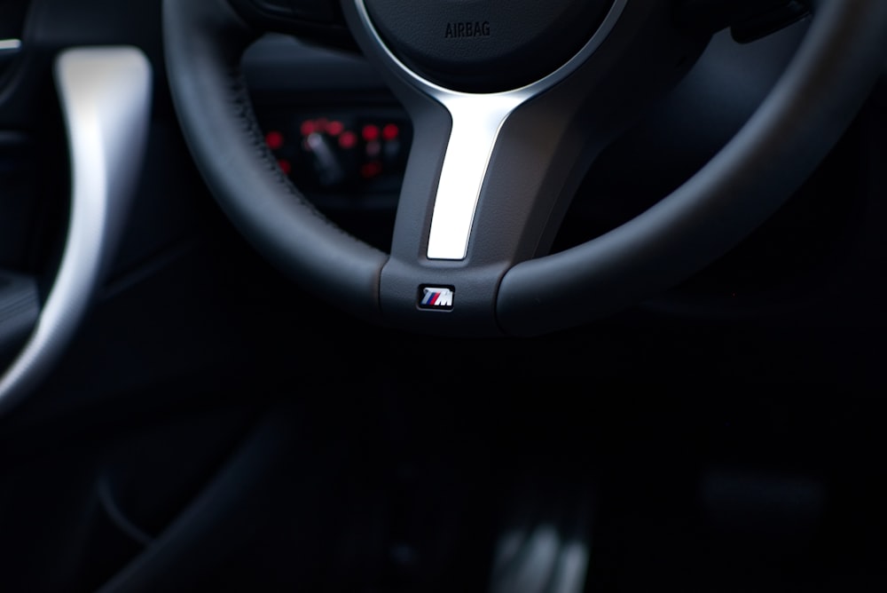 macro photography of black vehicle steering wheel