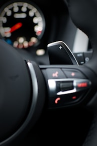 Close-up of a car dashboard showing sport mode activation.