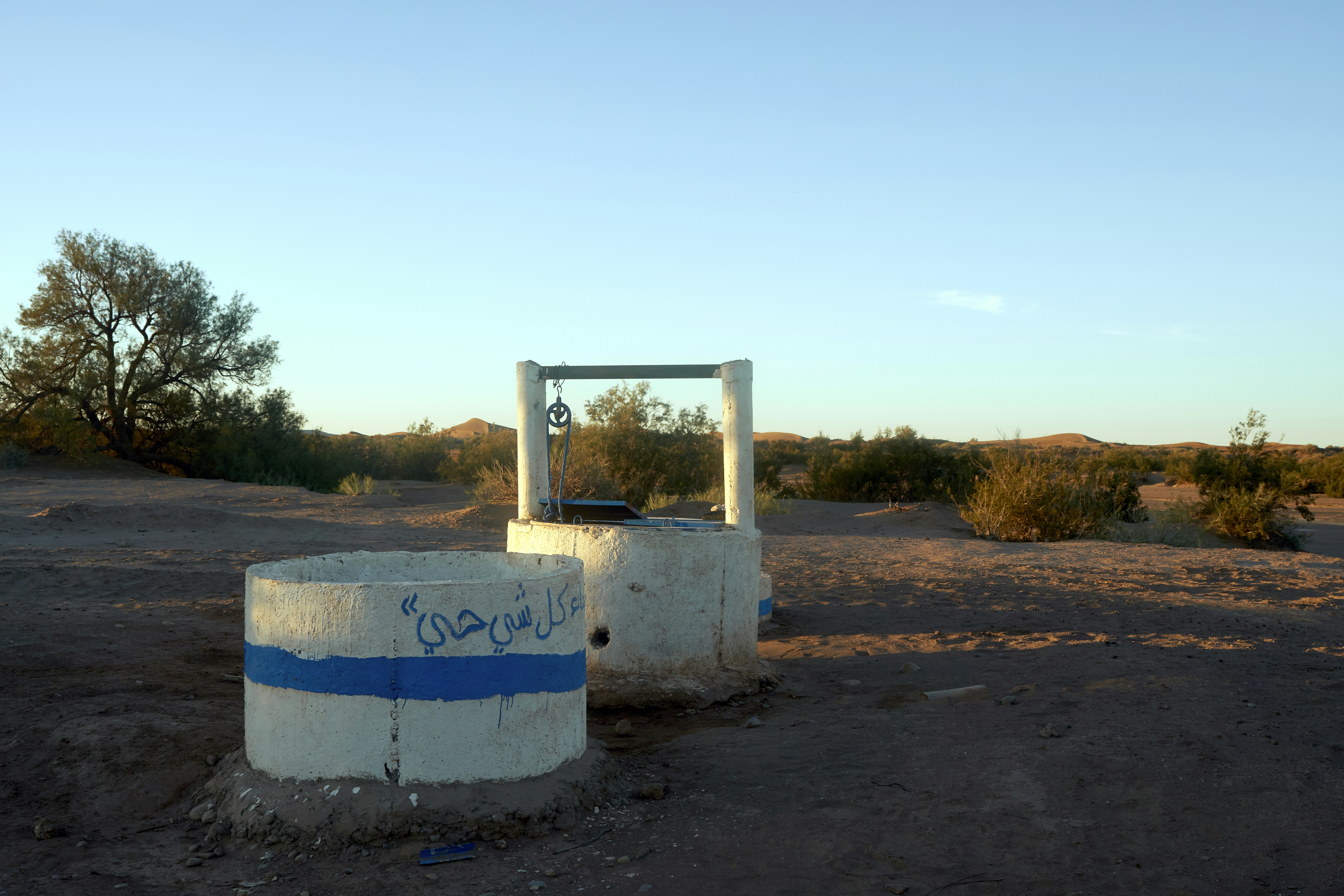 A newly built water well in a dry, rural area, symbolizing a sustainable charity project providing ongoing benefits - sadaka meaning