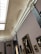 An art gallery with ornately decorated ceilings and walls showcasing various framed paintings. The gallery features classical architectural elements, including molding and pilasters. Several pieces of art, including portraits and larger paintings, hang on the walls.