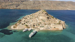 cruise ship and boats docked beside isle with buildings