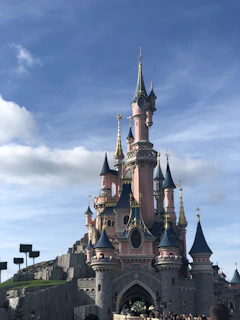 A sky castle floating among clouds, built with pastel-colored blocks and sparkles.