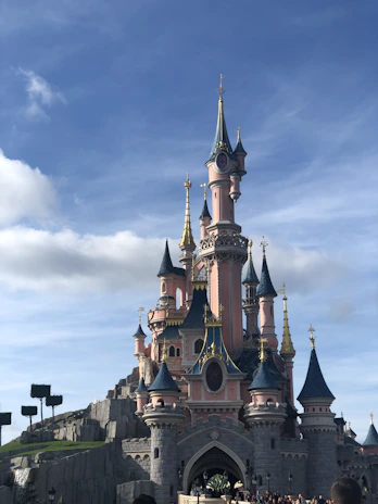 A sky castle floating among clouds, built with pastel-colored blocks and sparkles.