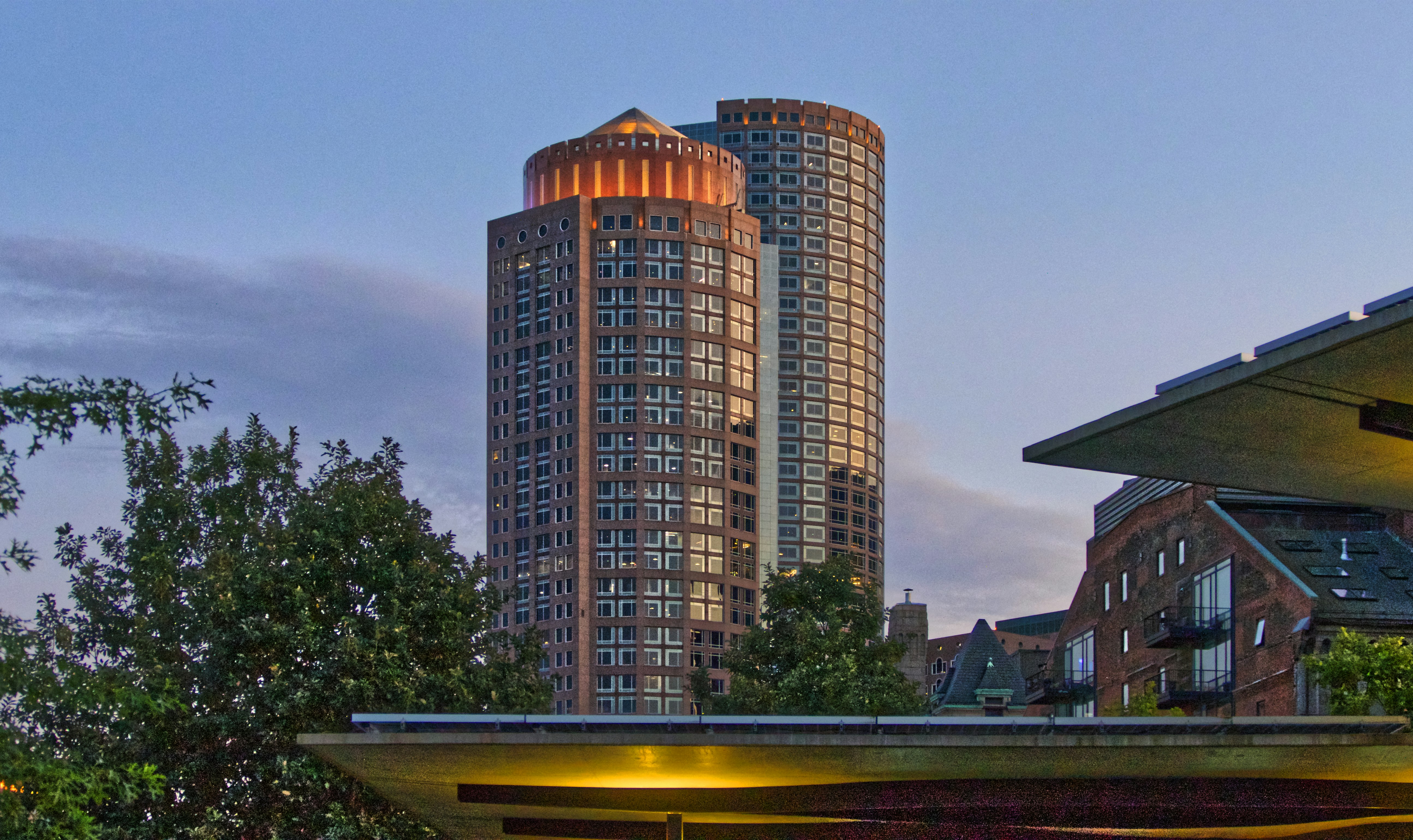 brown high-rise building near trees under blue and white sky massachusetts teams background