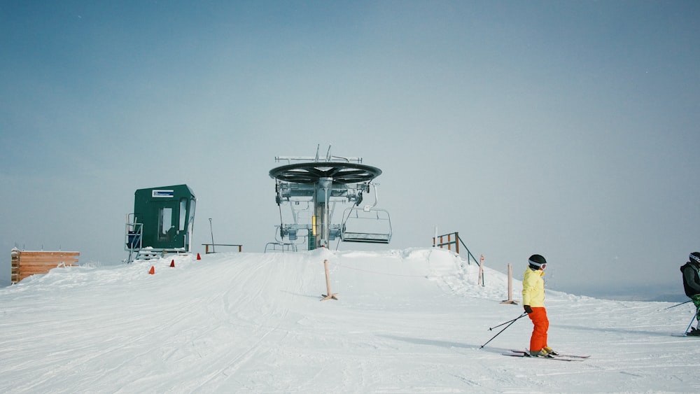 people wearing snow ski gears at the snowfield near ski lift during day