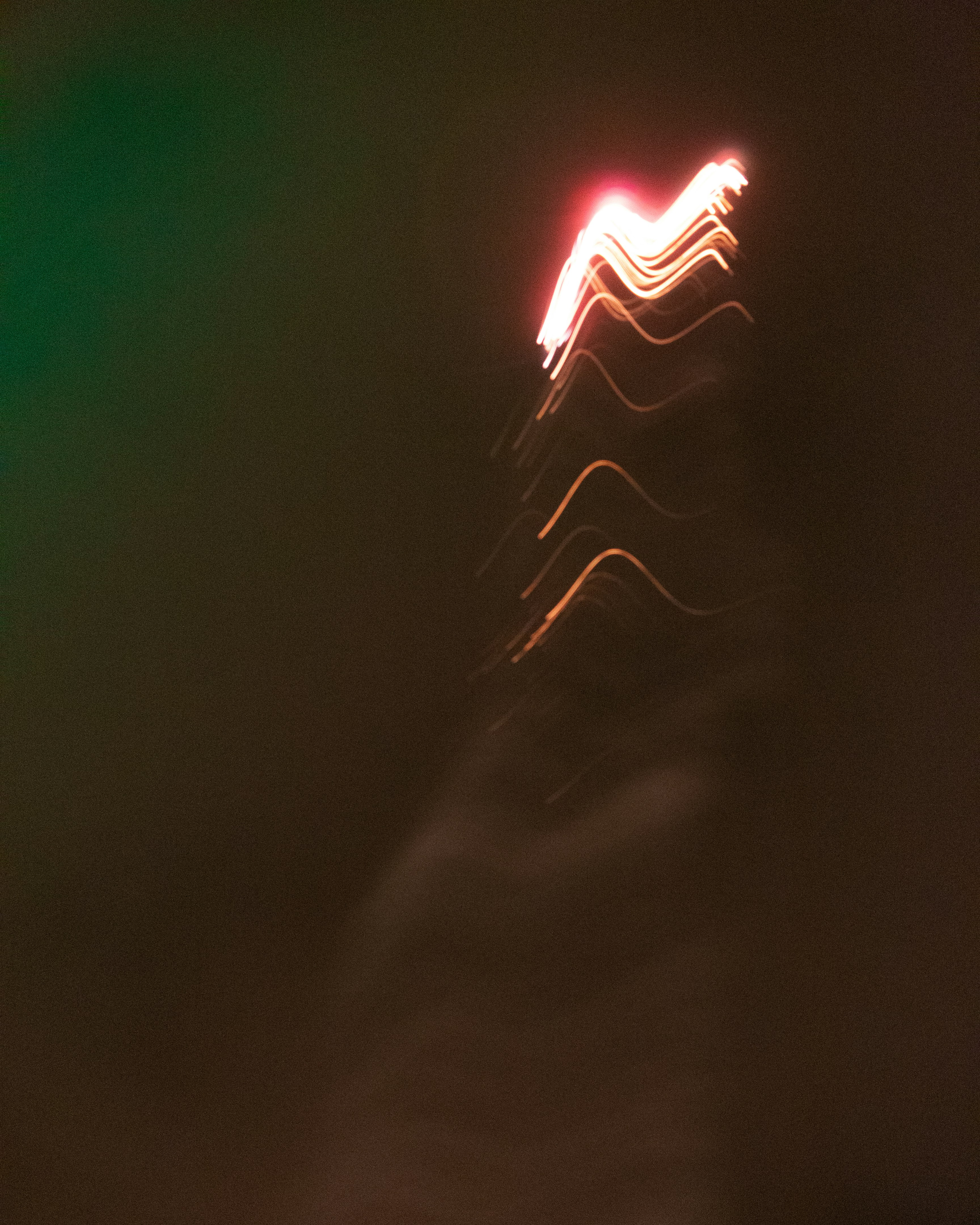 a blurry photo of a street light at night