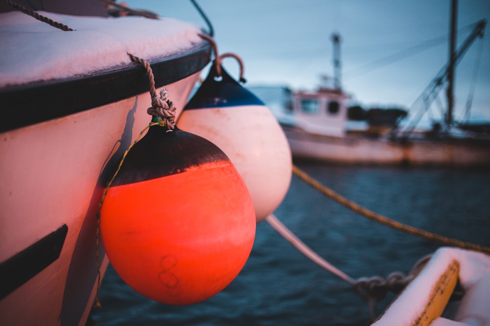 an orange buoy tied to a boat in the water