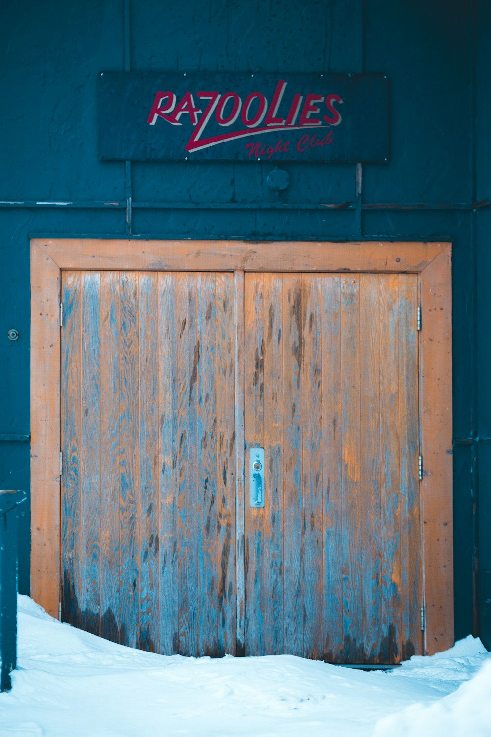 closed orange wooden door