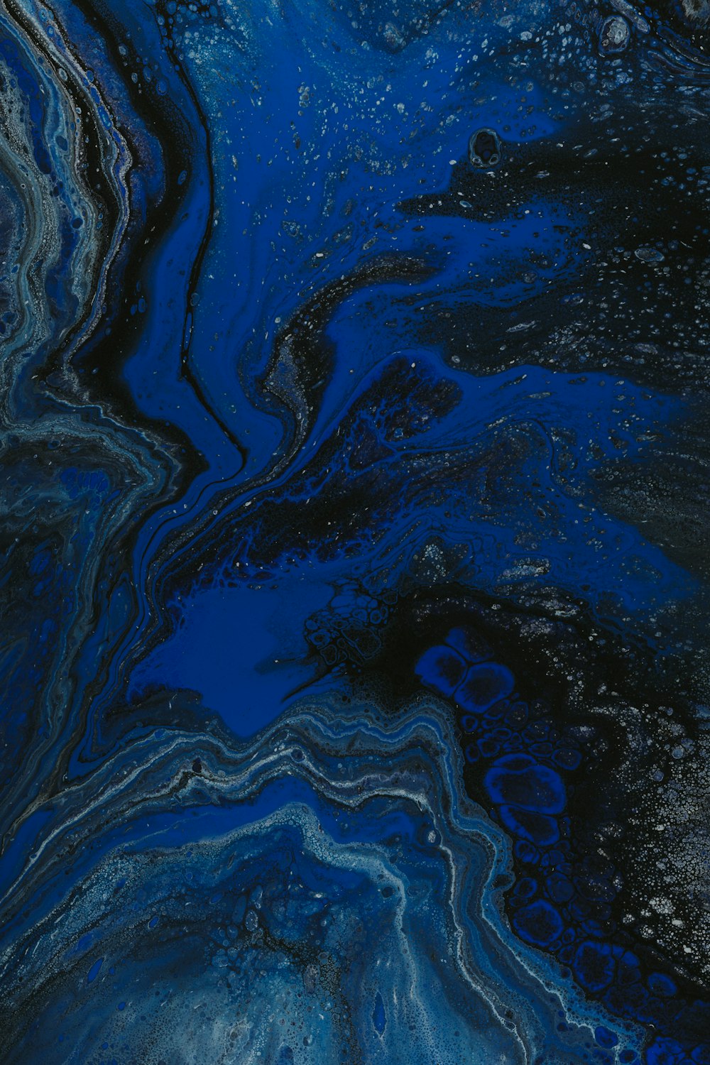 a close up of a blue and black liquid