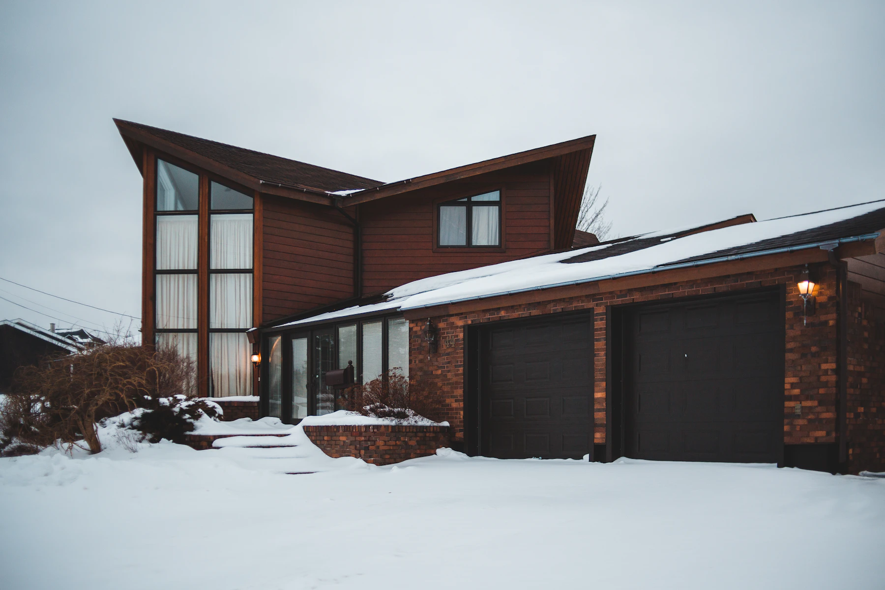 Closed residential garage doors on a suburban house
