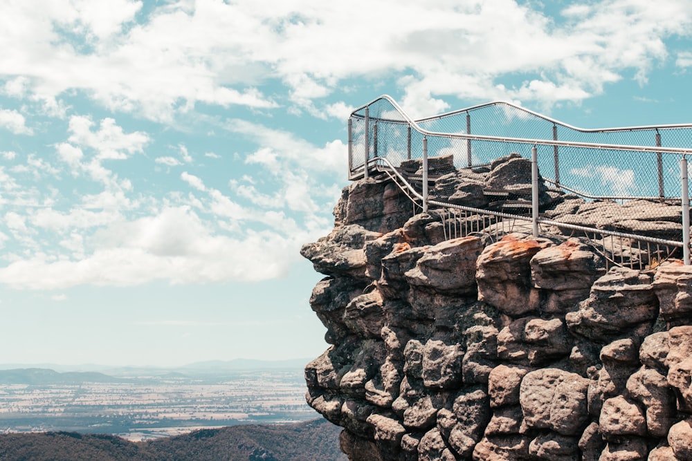 a man standing on top of a rocky cliff