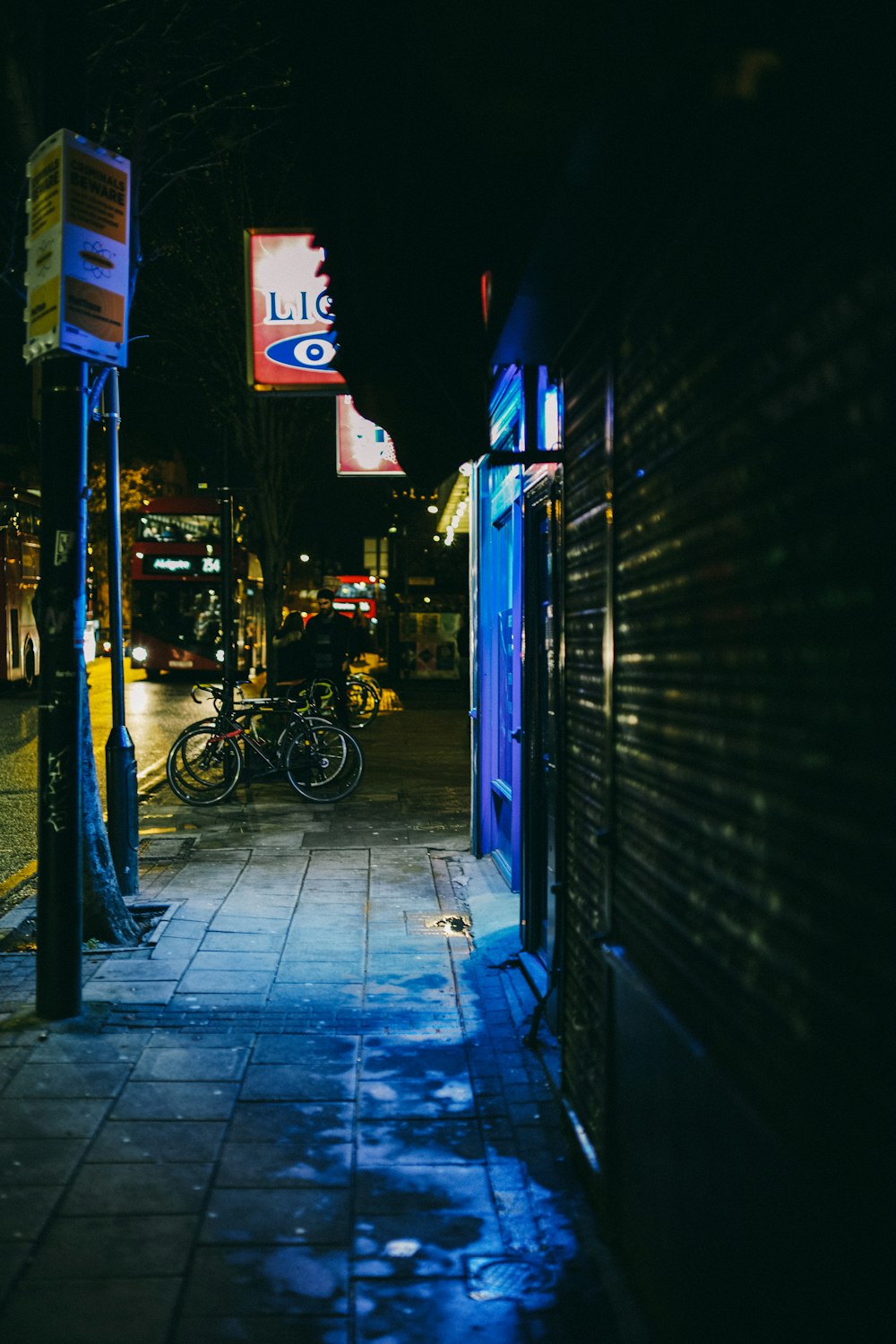 a dark street with a few bikes parked on the side of it