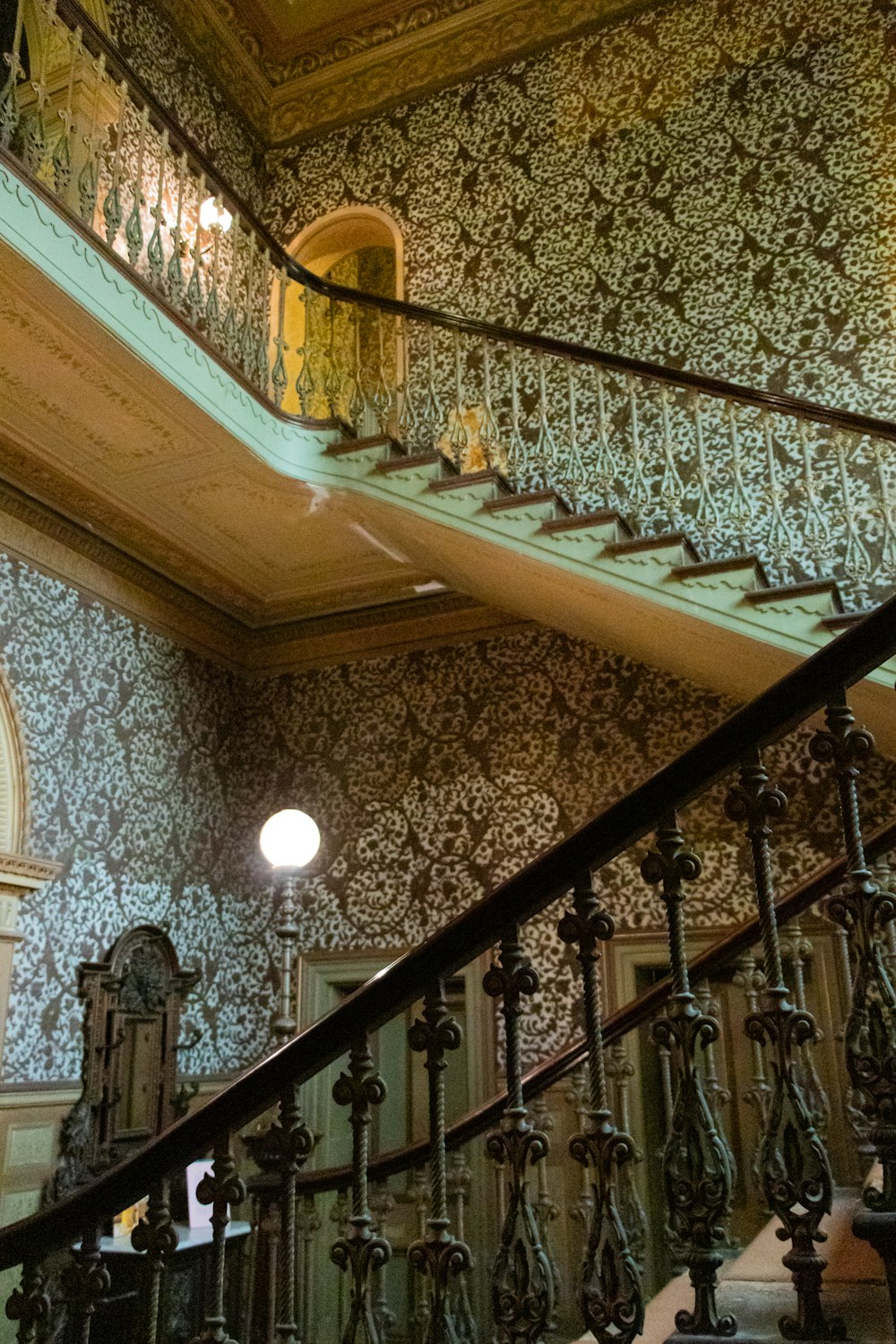 a staircase in a building with a clock on the wall