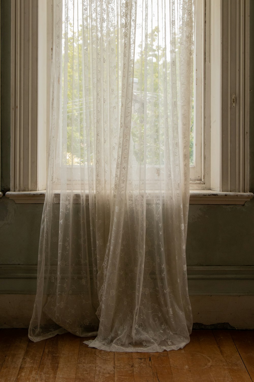 white sheer lace window curtain