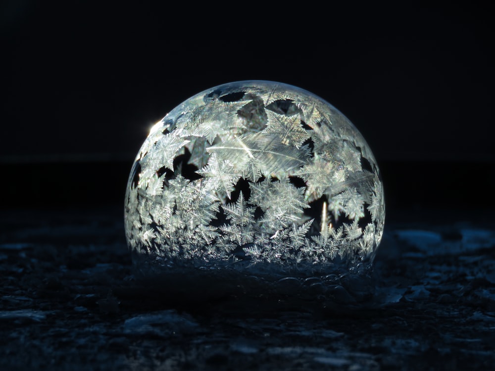 a glass ball with a lot of bats on it
