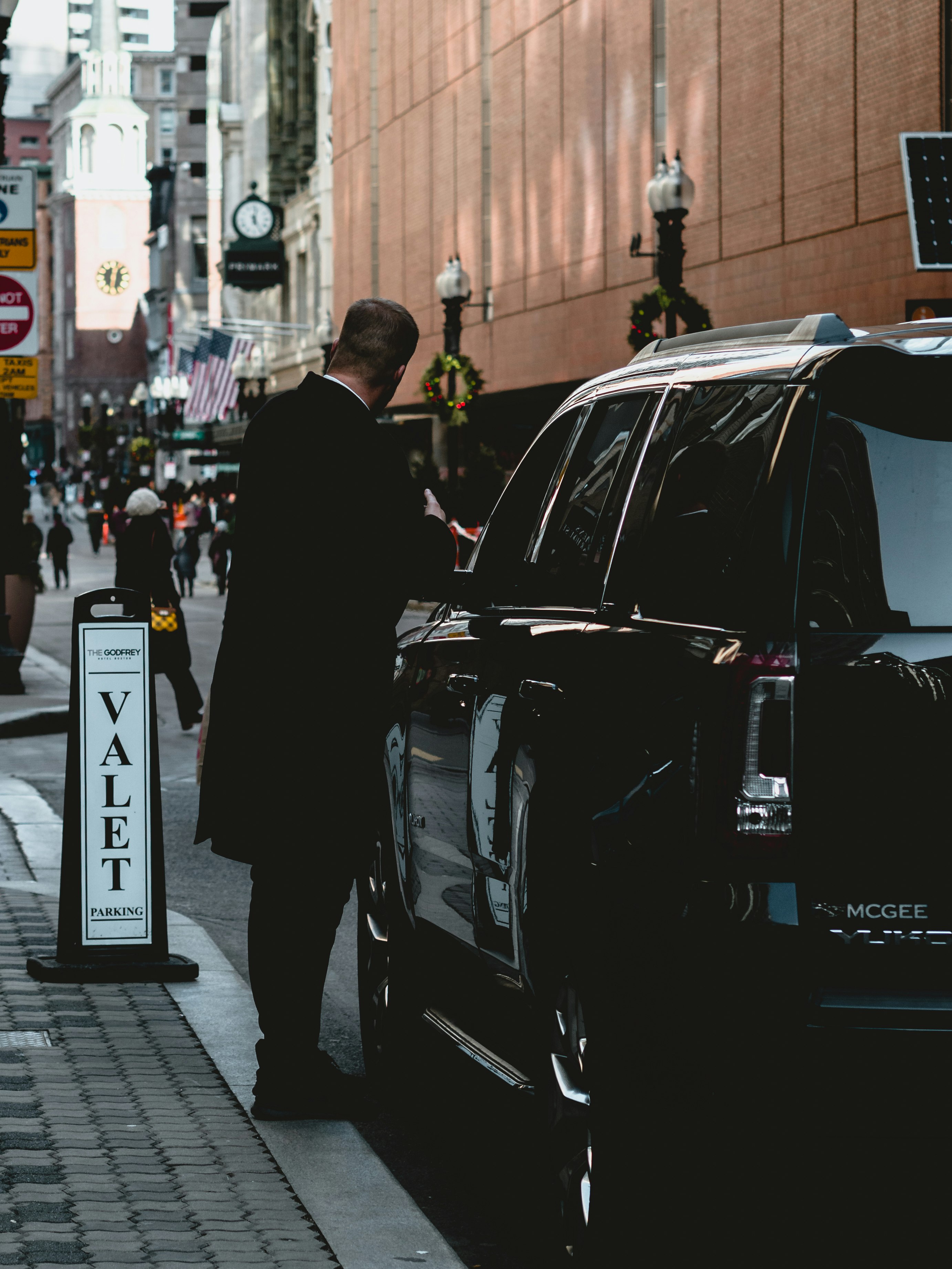 man standing beside vehicle