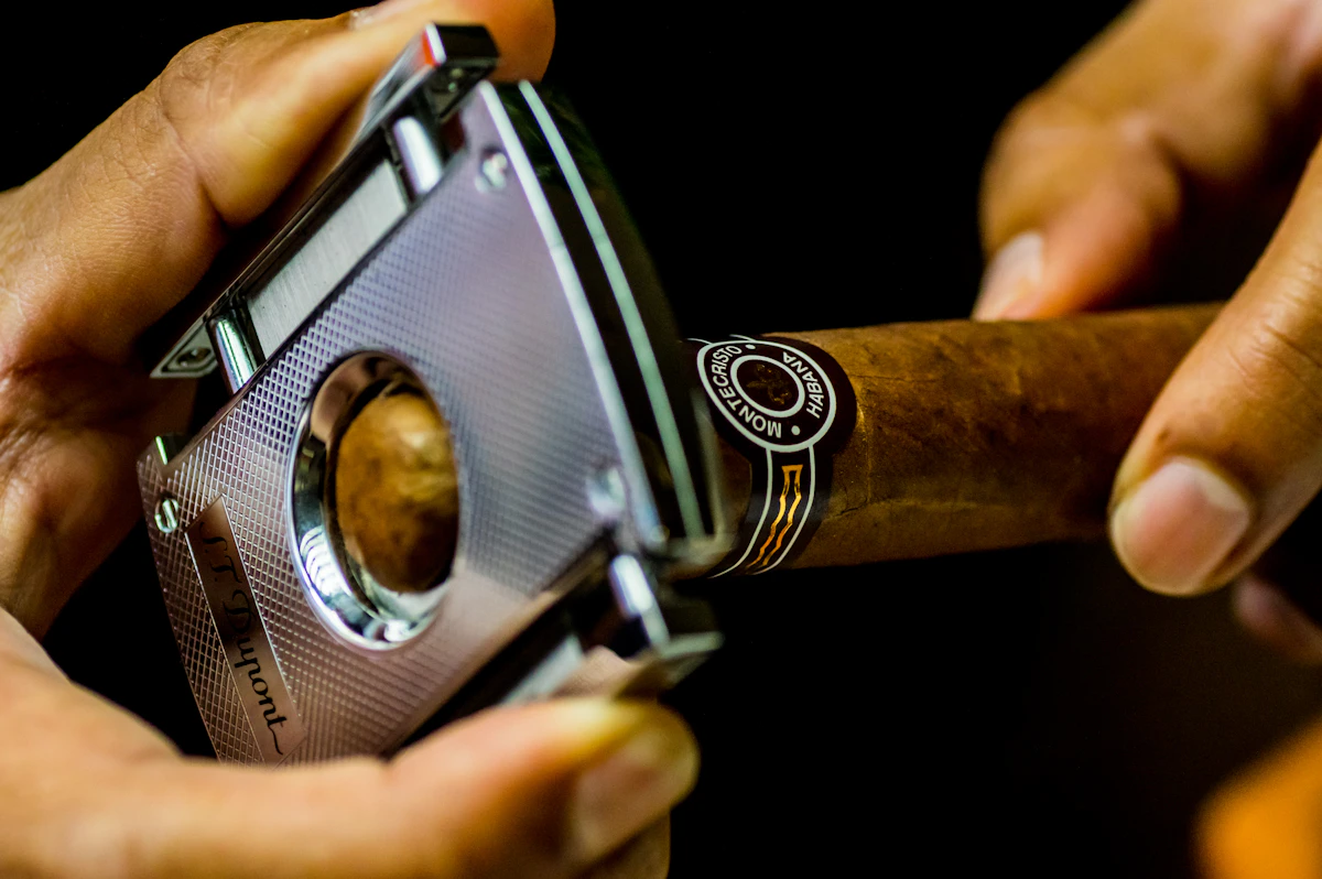Long cigar with light wrapper resting on dark felt surface.