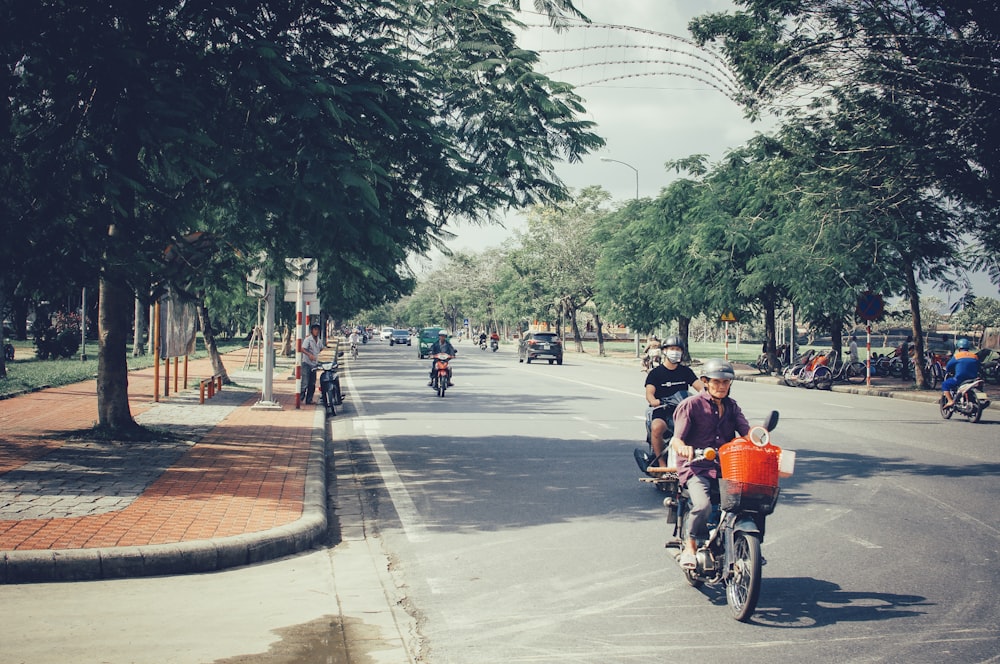 a group of people riding bikes down a street