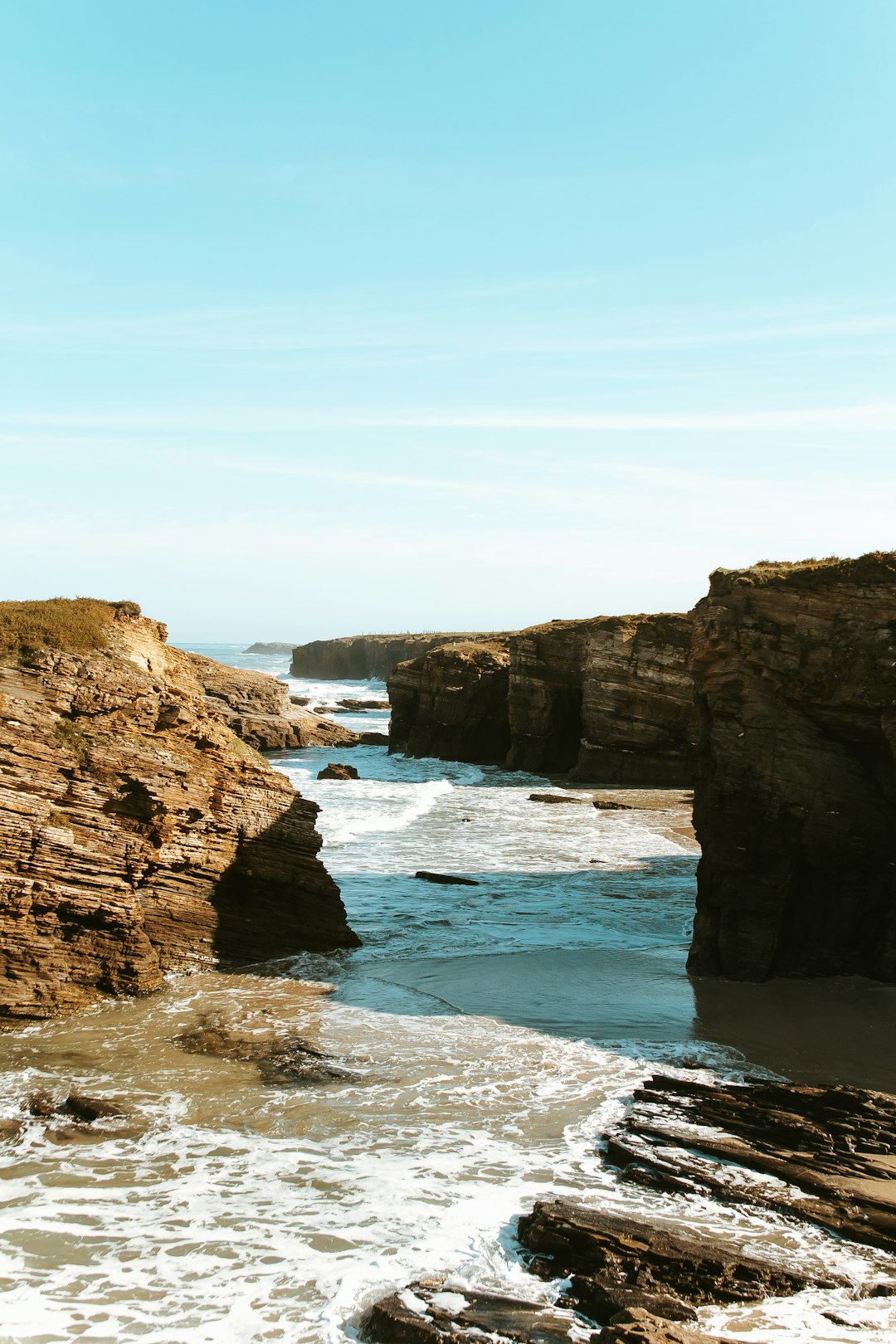 landscape photography of brown rock formation near body of water