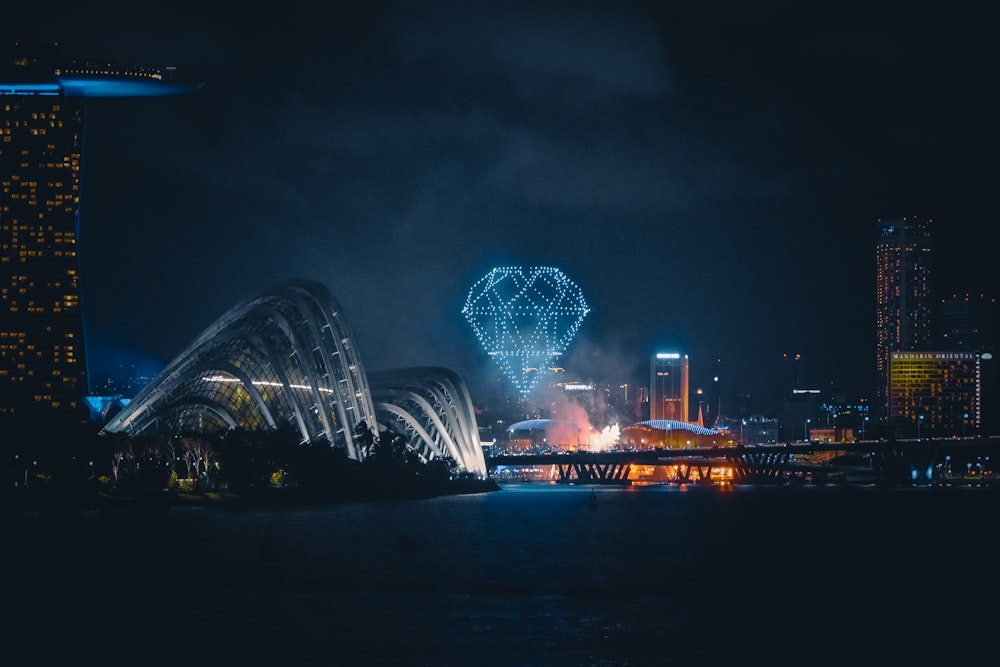 lighted city building near body of water