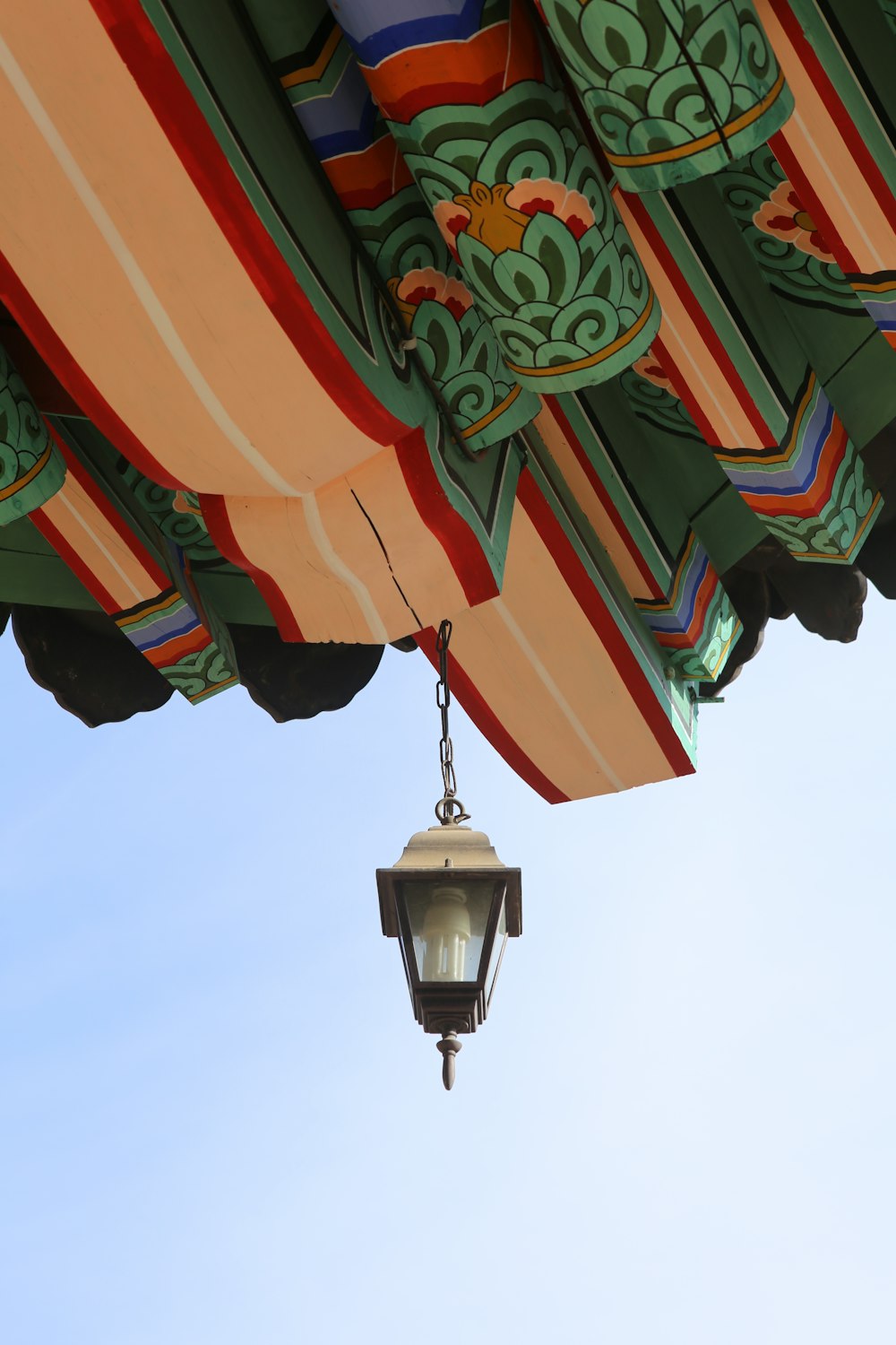 a street light hanging from the side of a canopy