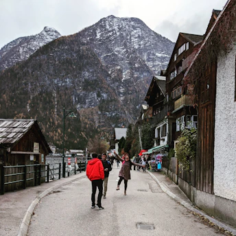 A traveler joyfully exploring a hidden village street with colorful houses.