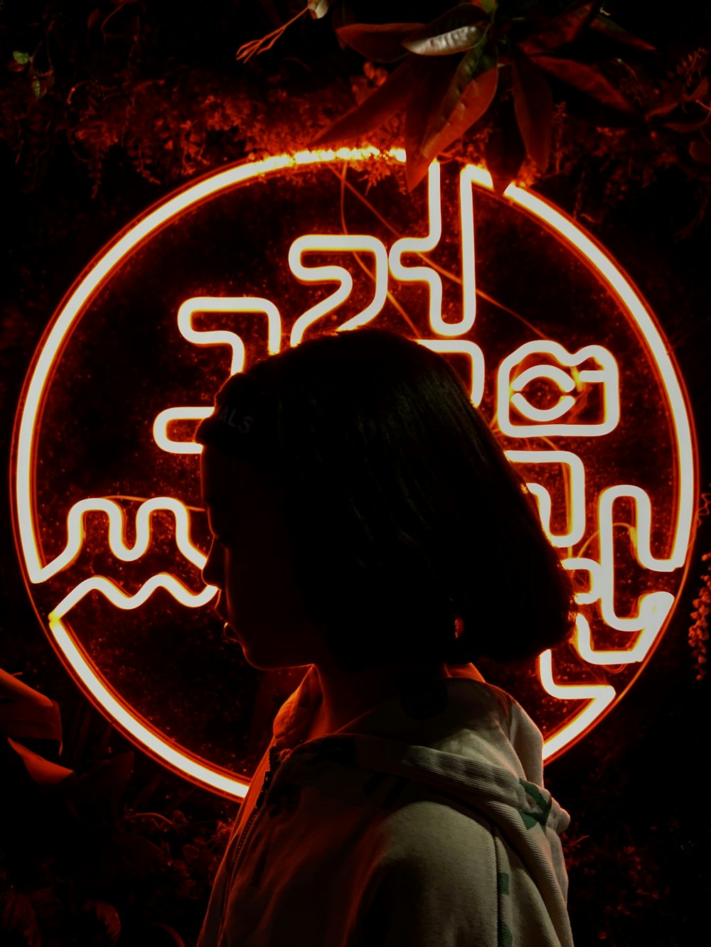 woman standing beside neon light