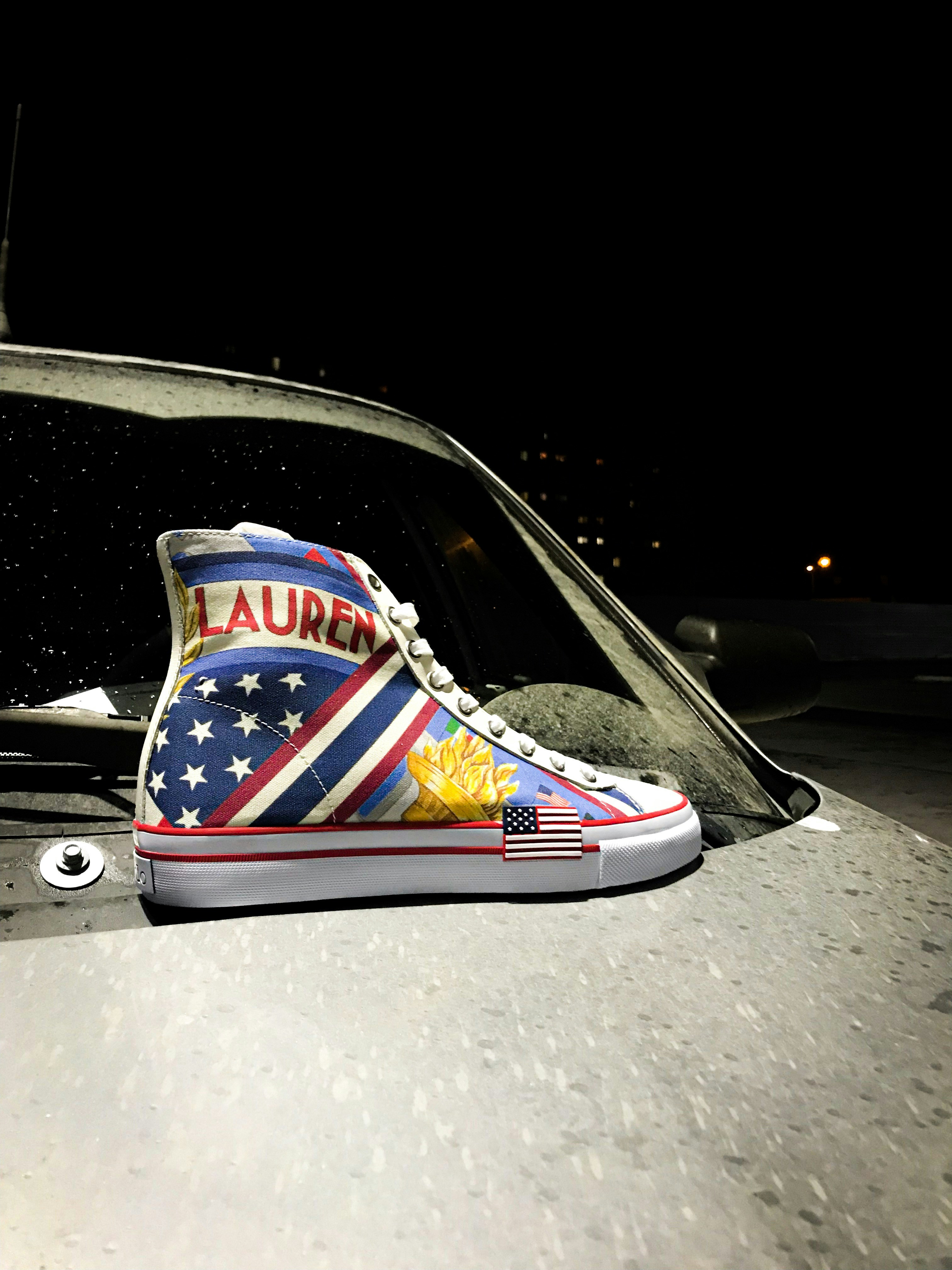 unpaired blue, white, and red high-top sneaker