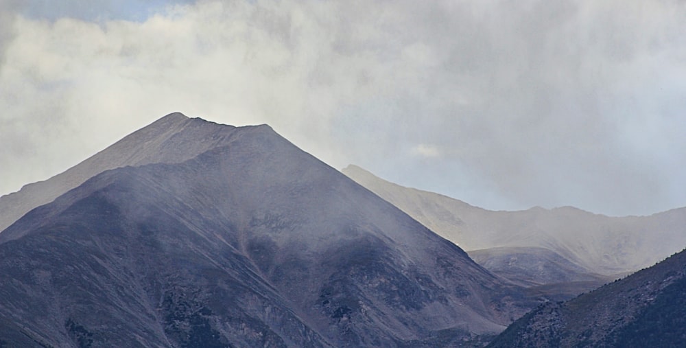 snow covered hills under white sky