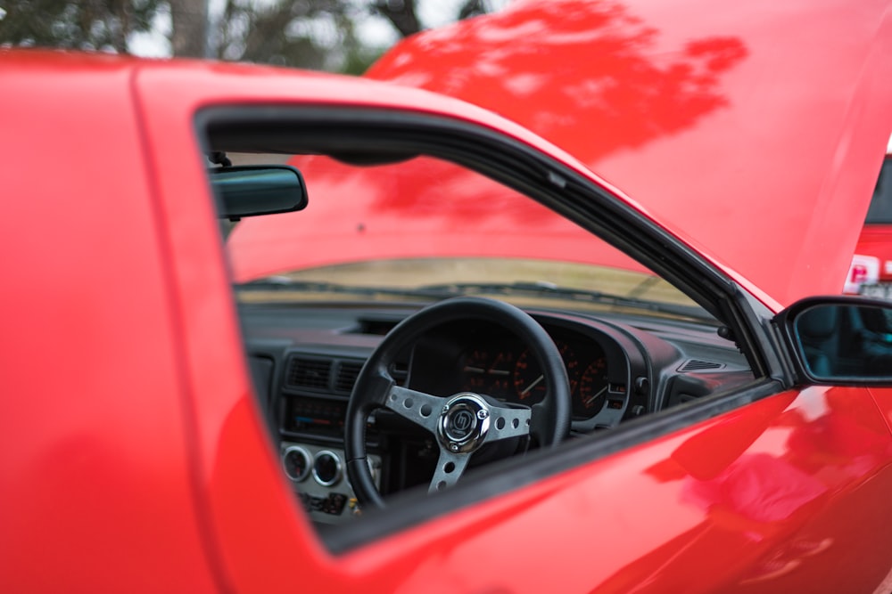 red car with an open hood