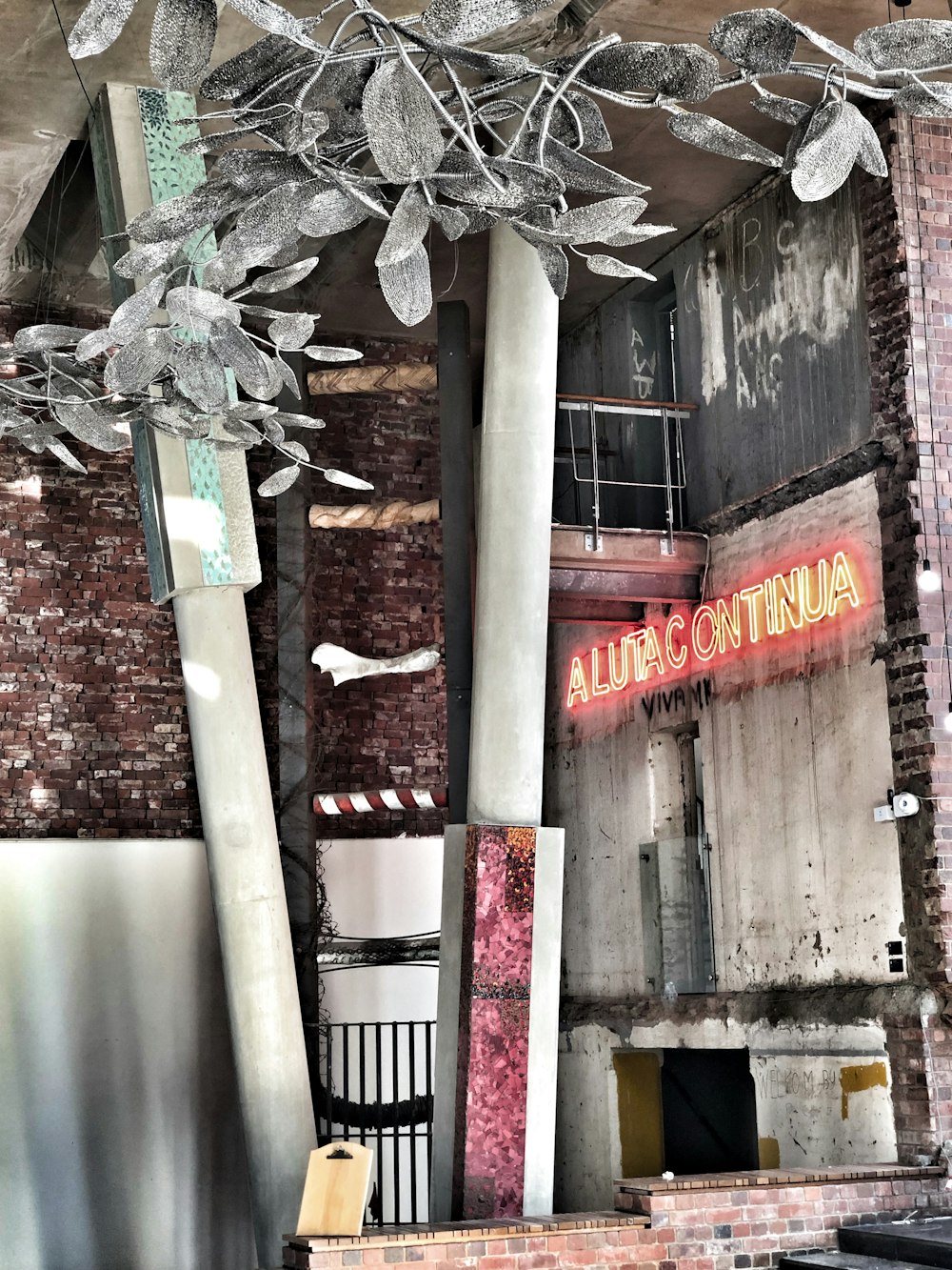 a very old building with a neon sign above it