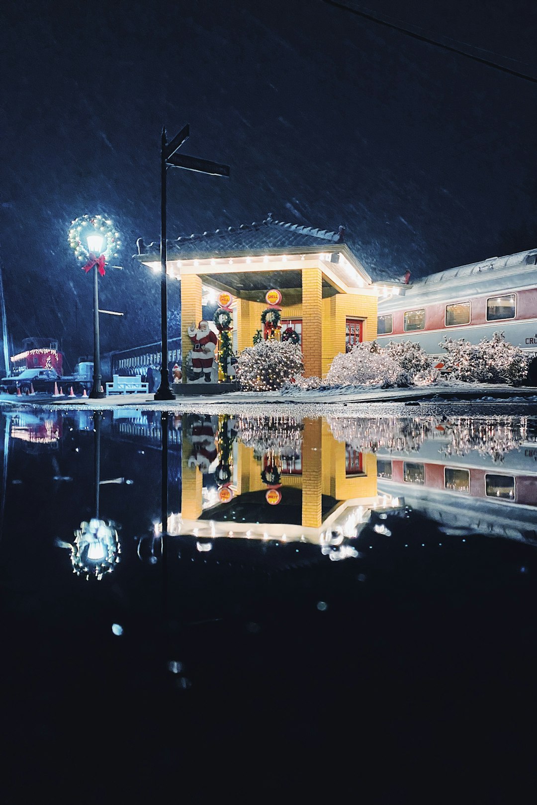 reflection of a house on body of water in the street during nighttime