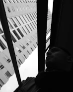 Black and white photo of Mr. Wagdy Elaraby reviewing architectural plans in his early career.