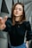 woman in black long-sleeved shirt standing near wall