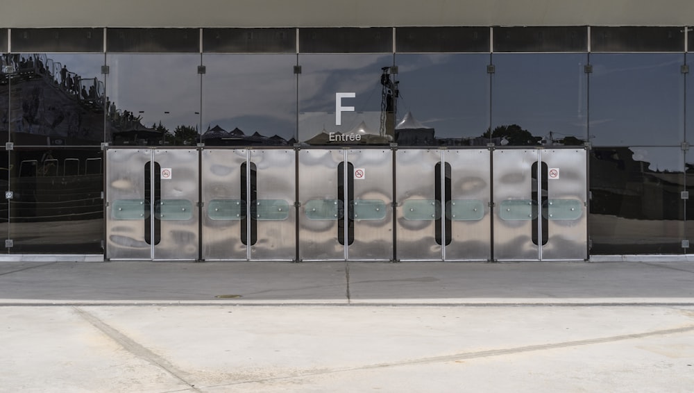 landscape photography of silver trash bins outside a building